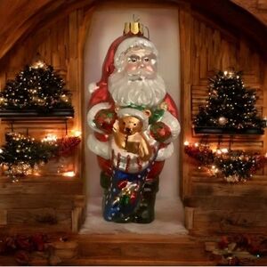 Santa Claus glass Christmas ornament holding teddy bear and a bag of gif…